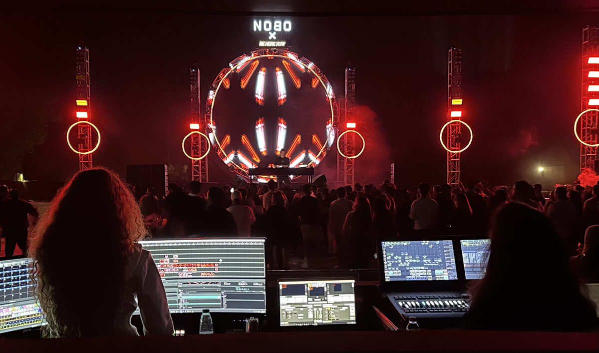 Ecube FOH desk at Nobo Music Festival — consoles, crowd, and circular stage rig